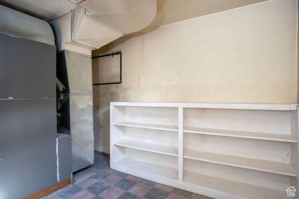 Unfurnished room with tile patterned floors and heating unit