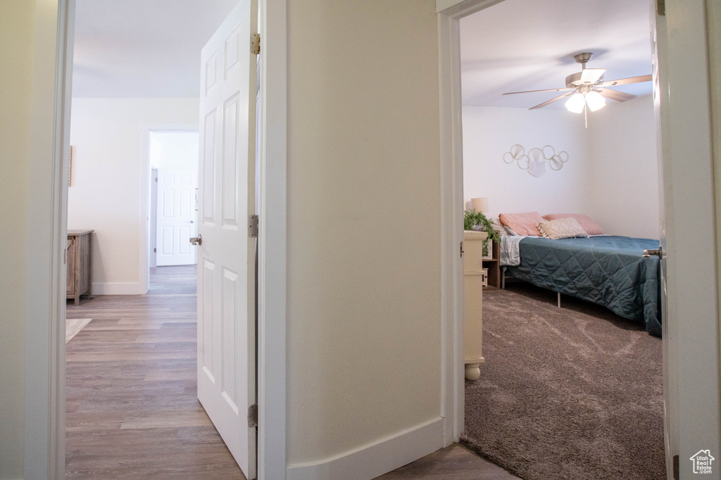 Hall with wood finished floors and baseboards
