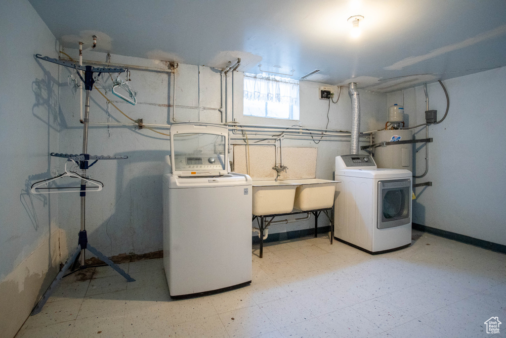 Basement with washing machine and dryer and tile patterned floors
