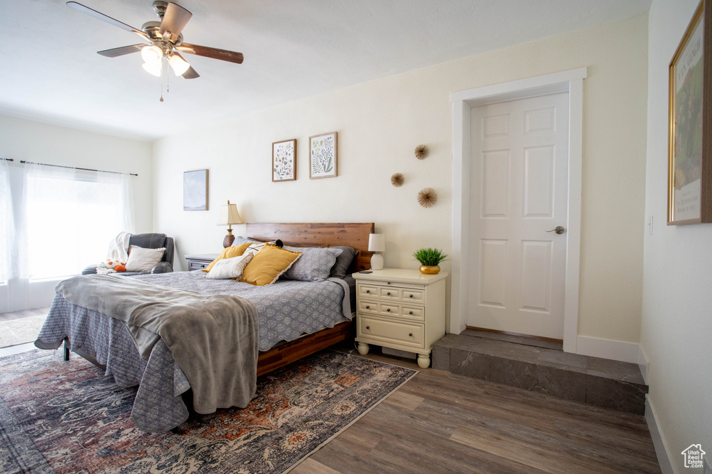 Bedroom with dark wood finished floors and a ceiling fan