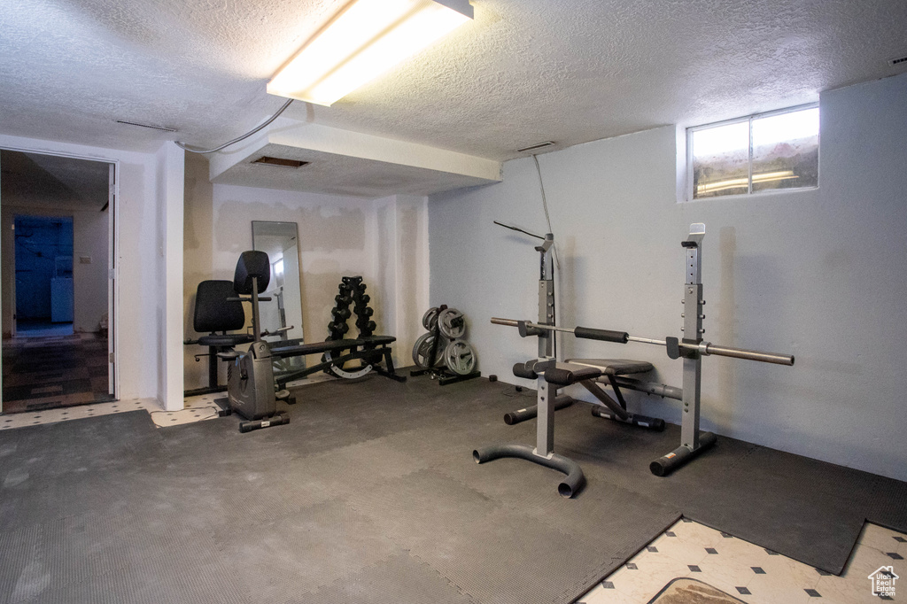 Exercise area featuring a textured ceiling