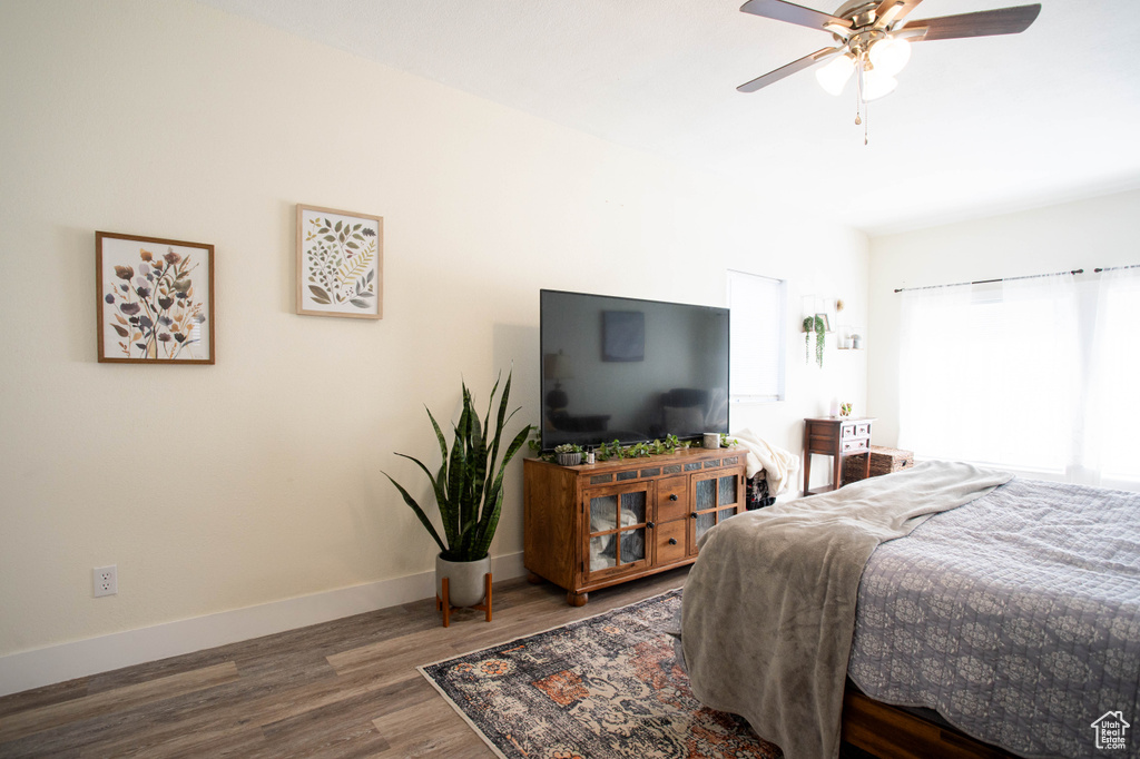 Bedroom with wood finished floors and ceiling fan