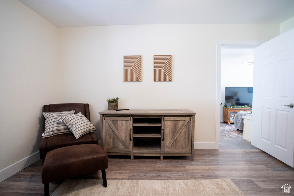 Sitting room with light wood-type flooring and baseboards