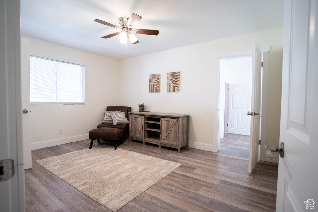 Sitting room featuring a ceiling fan and wood finished floors