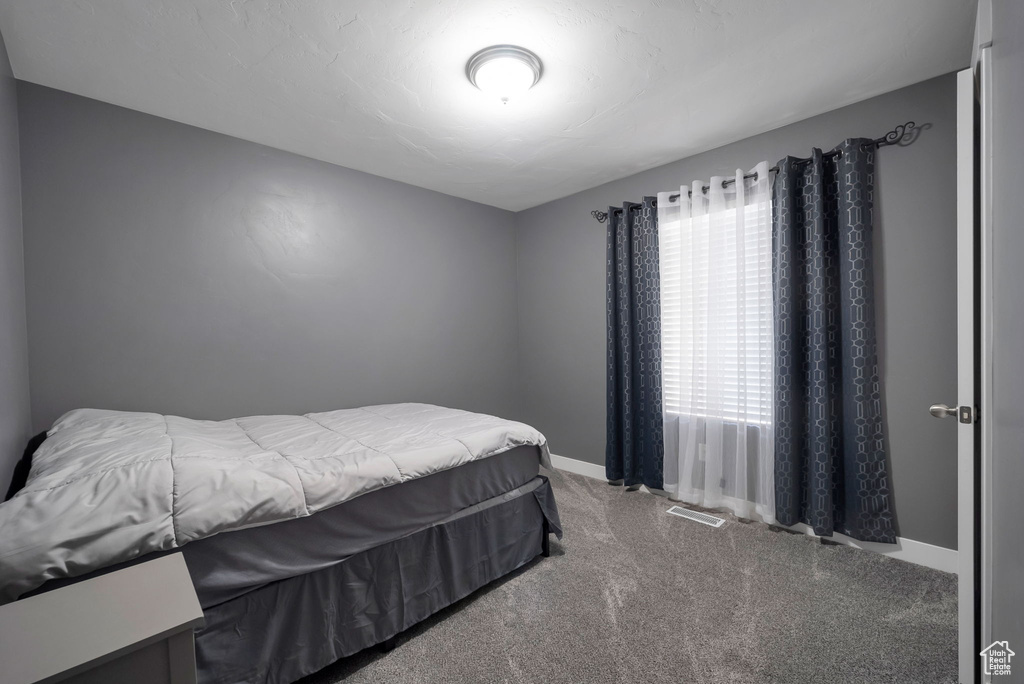 Carpeted bedroom featuring baseboards