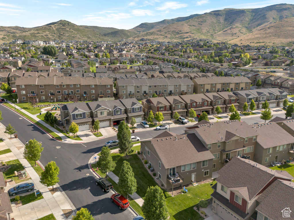 Aerial overview of property's location featuring nearby suburban area and a mountain backdrop