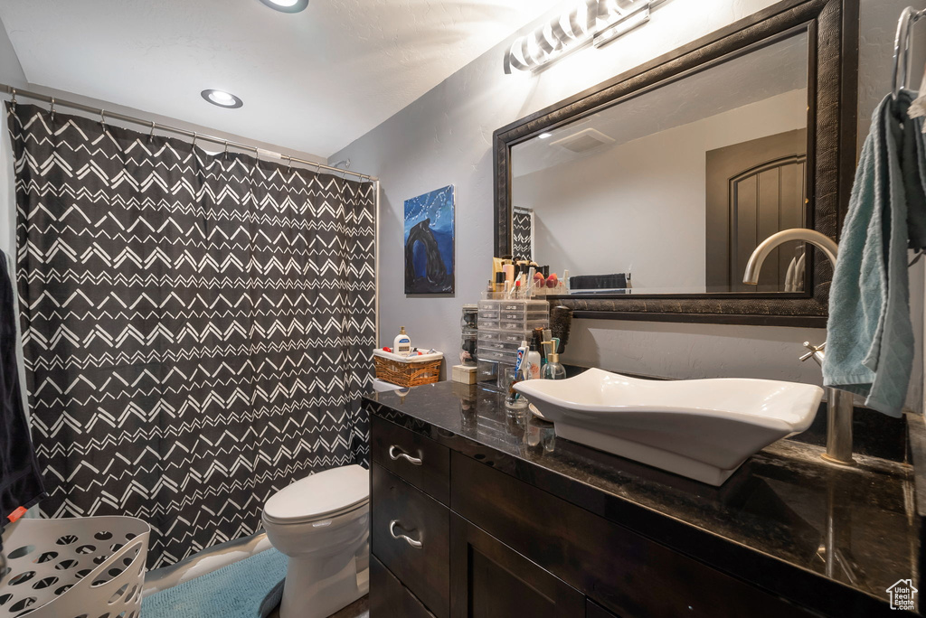 Bathroom featuring vanity, recessed lighting, and a shower with shower curtain