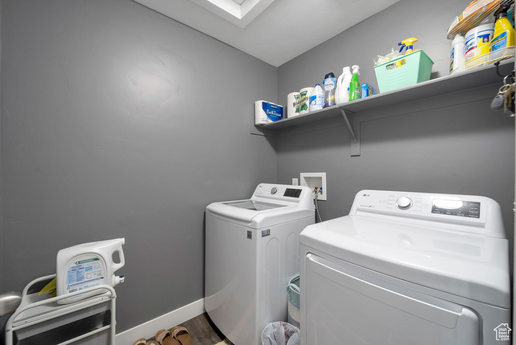 Laundry room featuring washer and clothes dryer and baseboards