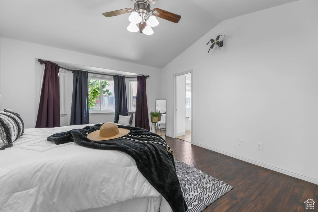 Bedroom with wood finished floors, lofted ceiling, and ceiling fan