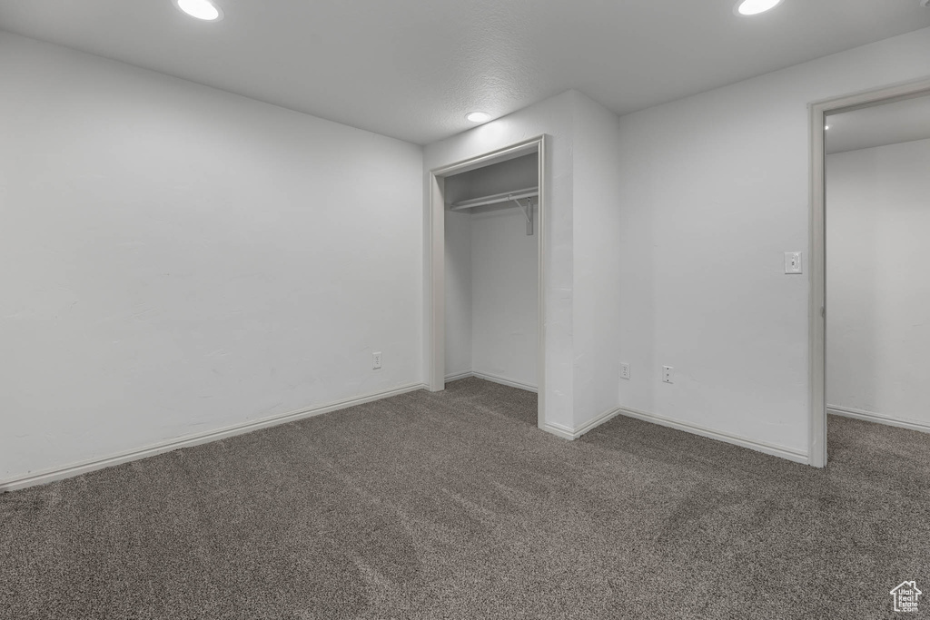 Unfurnished bedroom featuring carpet, recessed lighting, and a closet