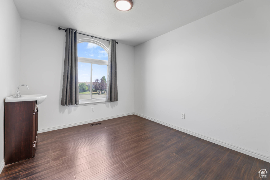 Spare room with dark wood finished floors