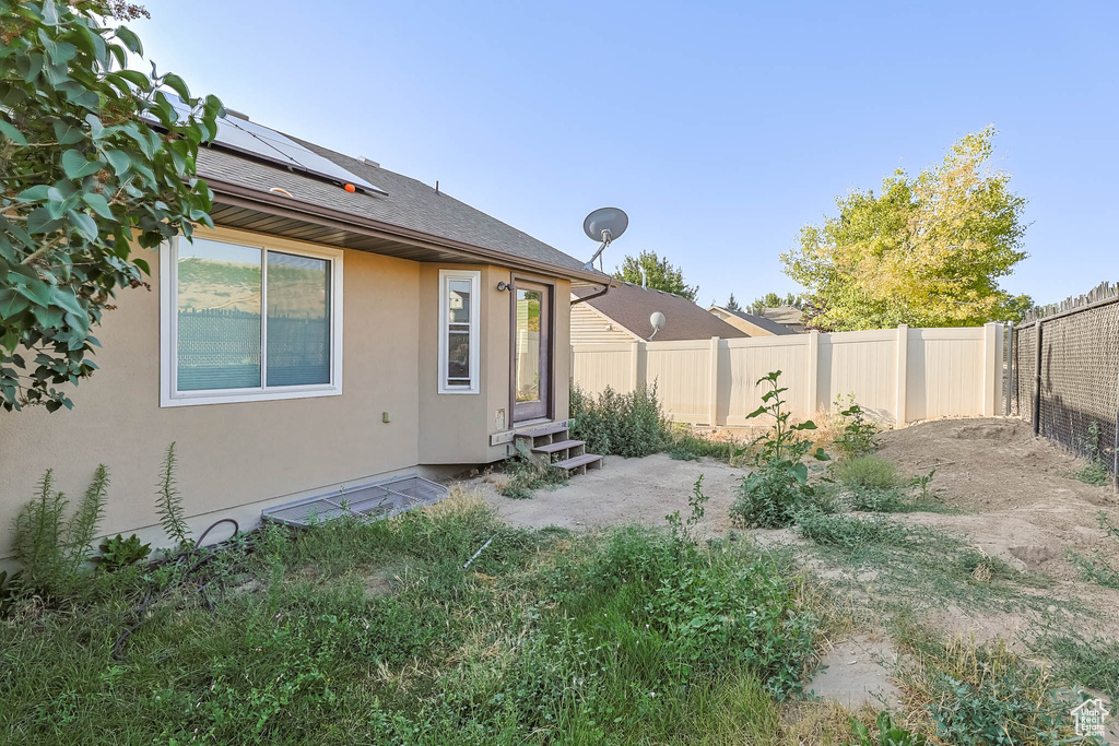 Fenced backyard featuring entry steps