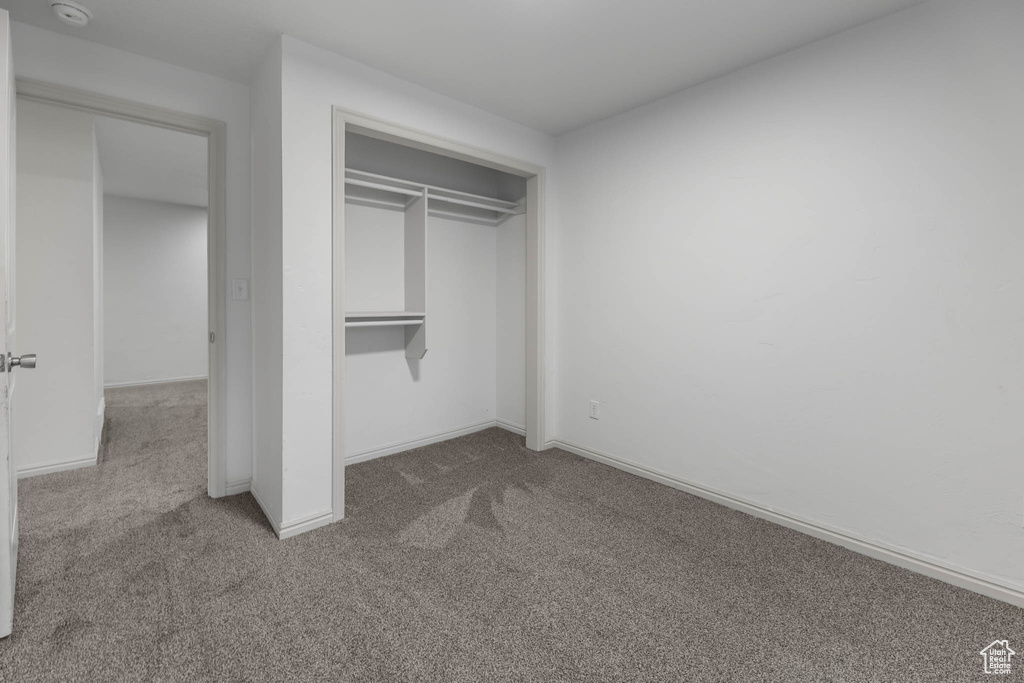 Unfurnished bedroom with carpet floors and a closet
