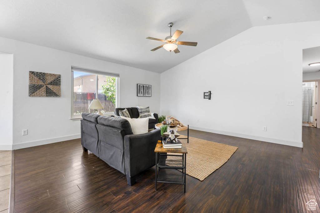Living room featuring vaulted ceiling, ceiling fan, and wood finished floors