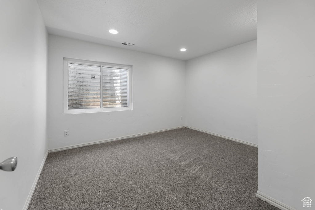 Spare room featuring carpet flooring and recessed lighting