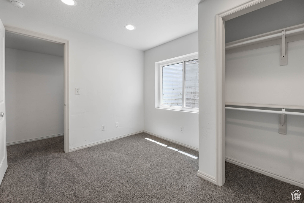 Unfurnished bedroom with carpet, recessed lighting, and a closet
