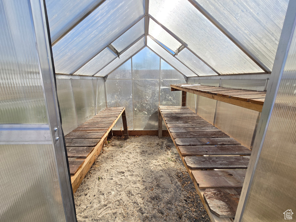 Unfurnished sunroom featuring vaulted ceiling and a sauna