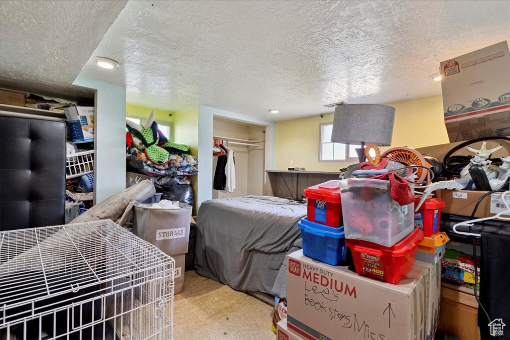 Bedroom featuring a textured ceiling and a closet
