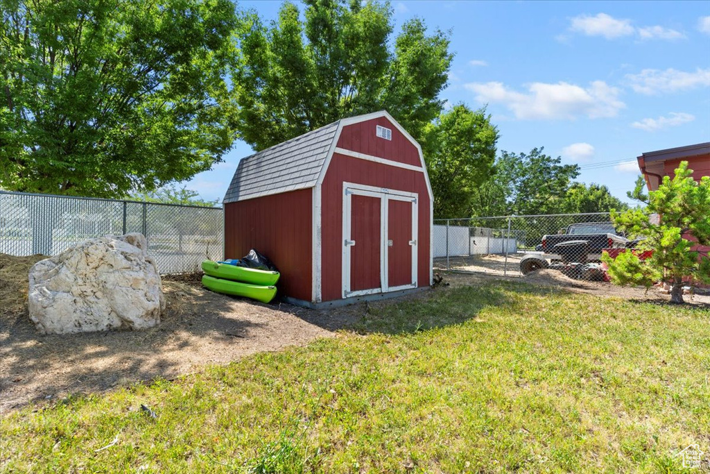 View of shed with a fenced backyard