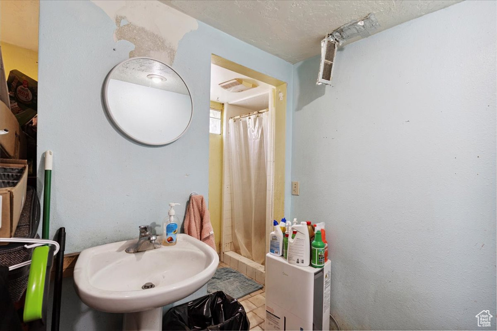 Full bath with a shower with curtain