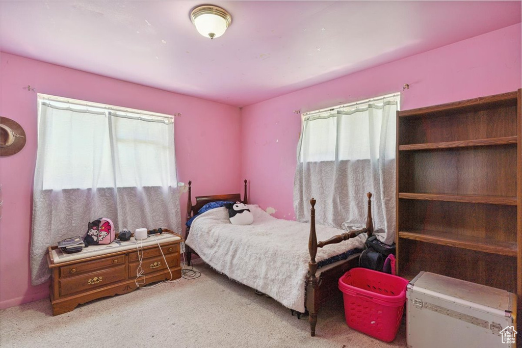 Carpeted bedroom featuring refrigerator