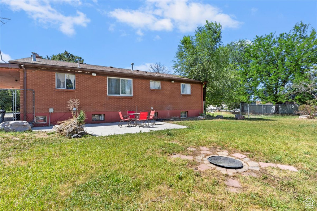 Rear view of property with a patio and brick siding