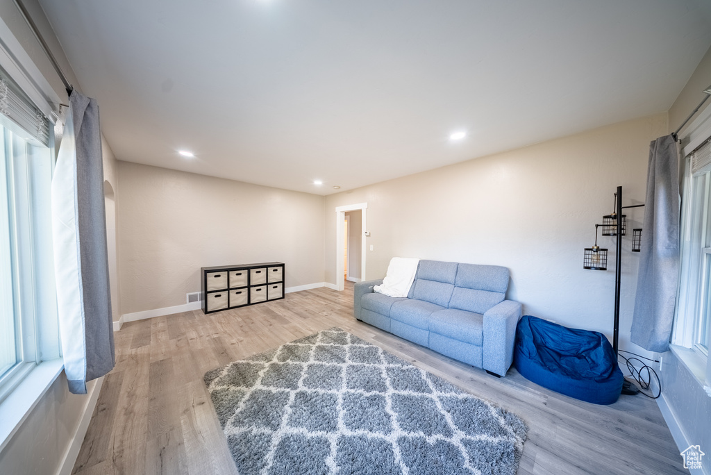 Sitting room with wood finished floors and recessed lighting