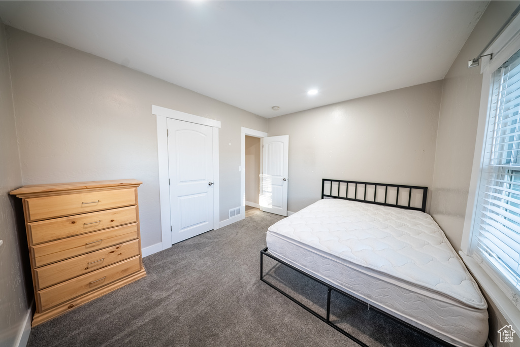 Bedroom with carpet and multiple windows