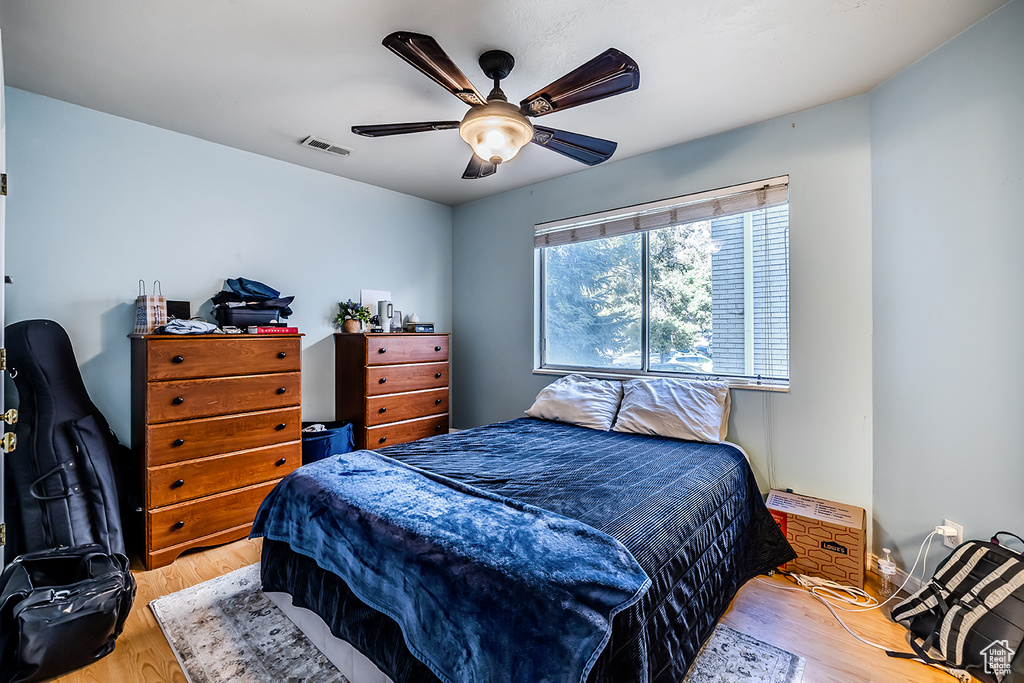 Bedroom with wood finished floors and a ceiling fan