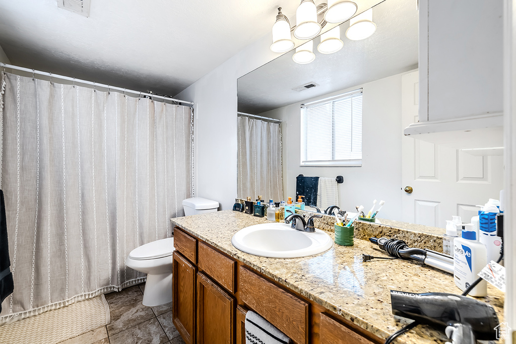 Bathroom featuring vanity, a chandelier, curtained shower, and tile patterned flooring