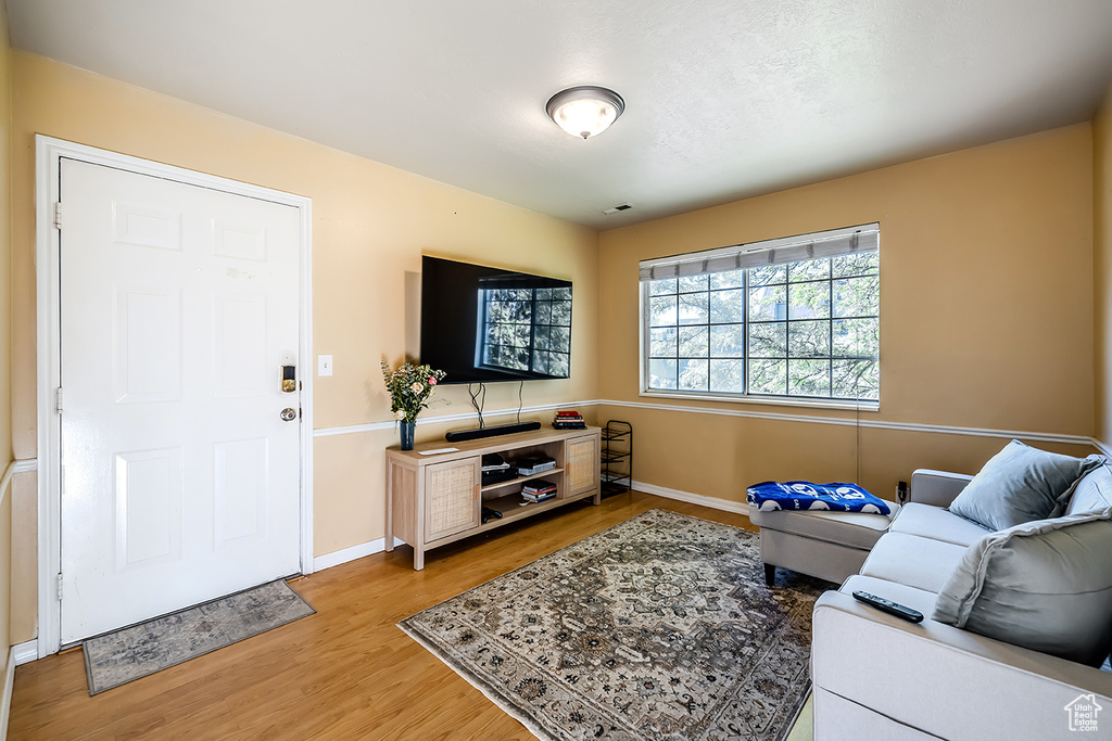 Living room with light wood-style flooring and baseboards