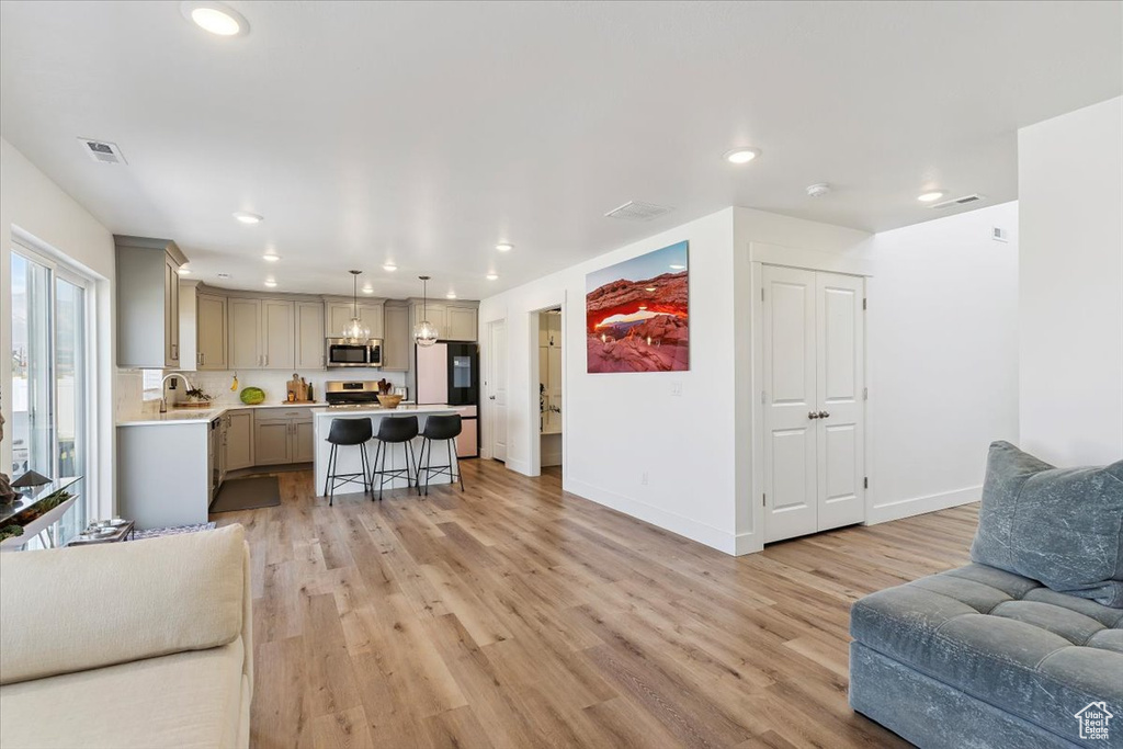 Living room featuring light wood finished floors and recessed lighting