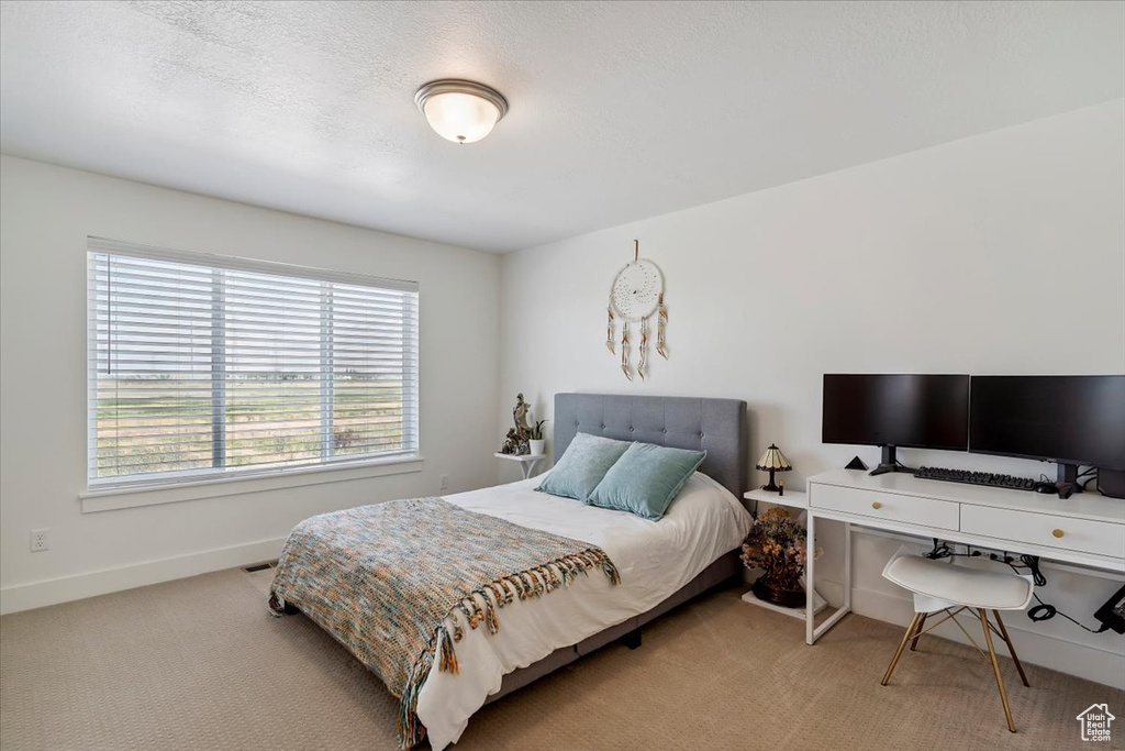 Carpeted bedroom featuring baseboards