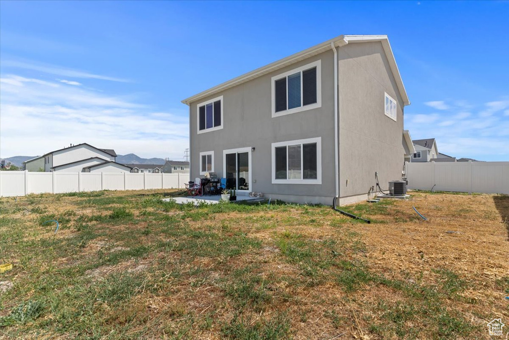 Rear view of property featuring a patio, a fenced backyard, and stucco siding