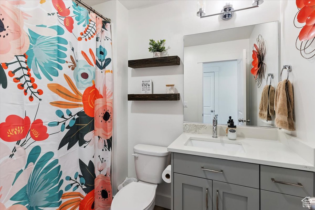 Full bathroom with vanity and a shower with shower curtain