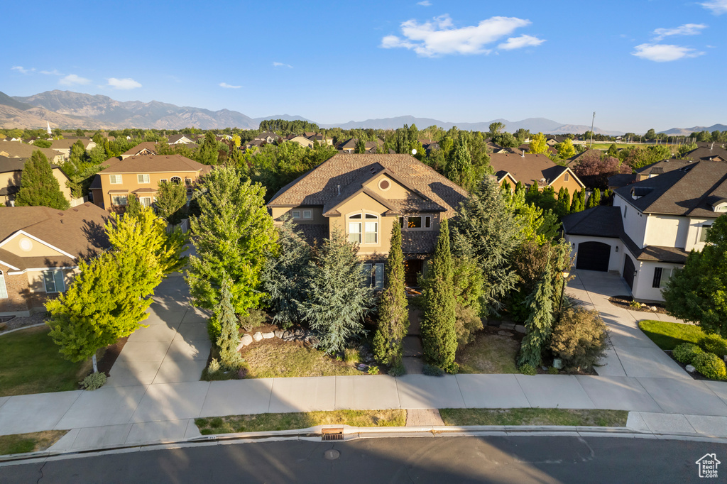 View of front facade featuring a residential view, a mountain view, and a garage