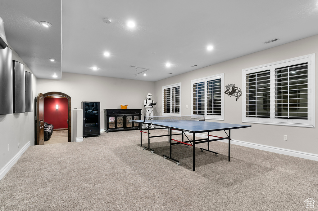 Rec room with attic access, carpet, recessed lighting, and arched walkways