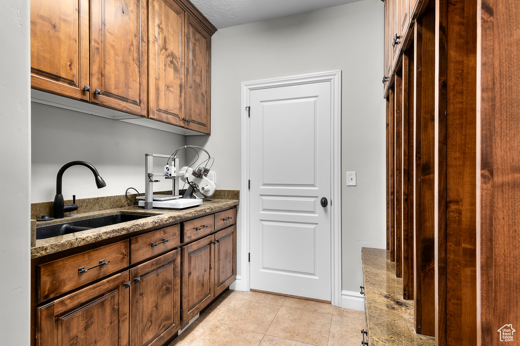 Washroom featuring light tile patterned floors and cabinet space