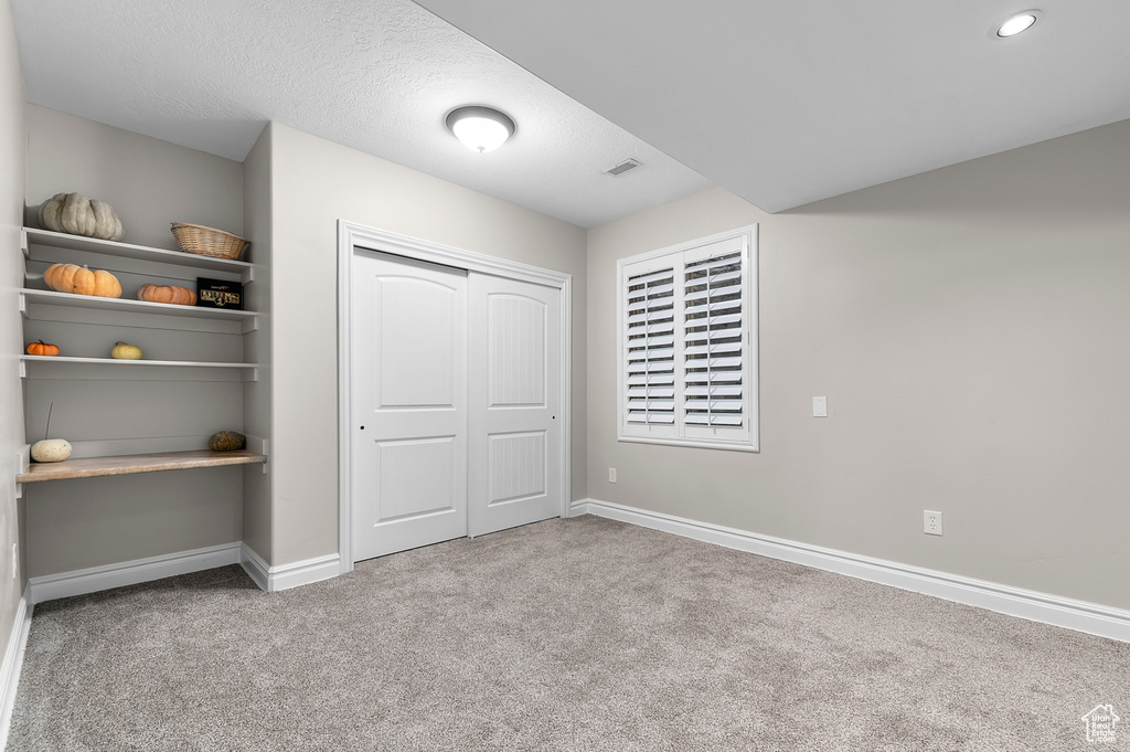 Unfurnished bedroom with carpet floors and a closet