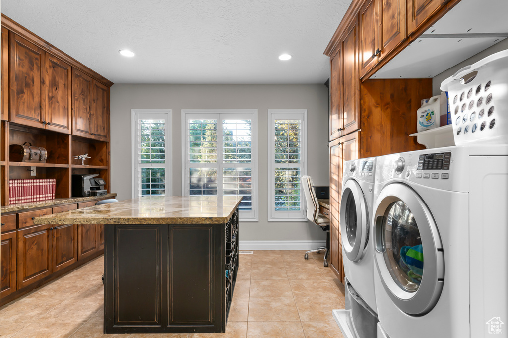Washroom with cabinet space, separate washer and dryer, recessed lighting, and light tile patterned floors