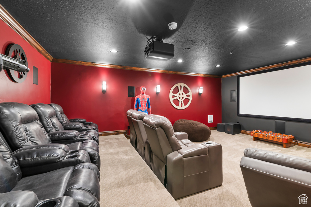 Cinema with ornamental molding, carpet, recessed lighting, and a textured ceiling