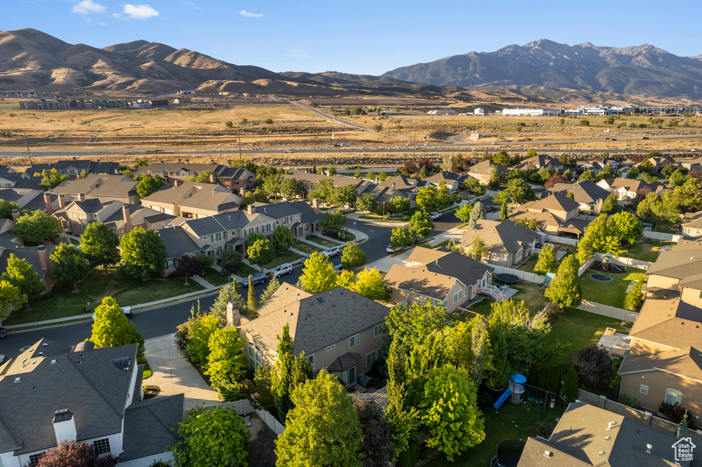 Aerial view of property and surrounding area with nearby suburban area and a mountainous background