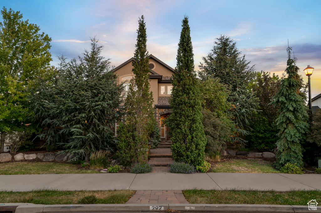 Obstructed view of property featuring stucco siding
