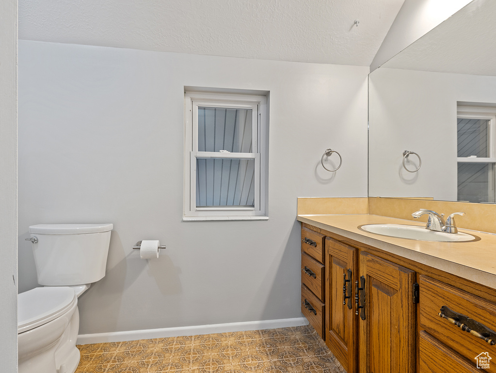 Bathroom featuring vanity and a textured ceiling