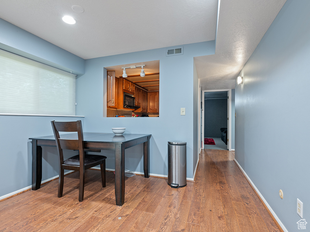 Dining room featuring light wood-type flooring and baseboards