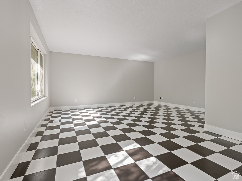 Unfurnished room featuring tile patterned floors