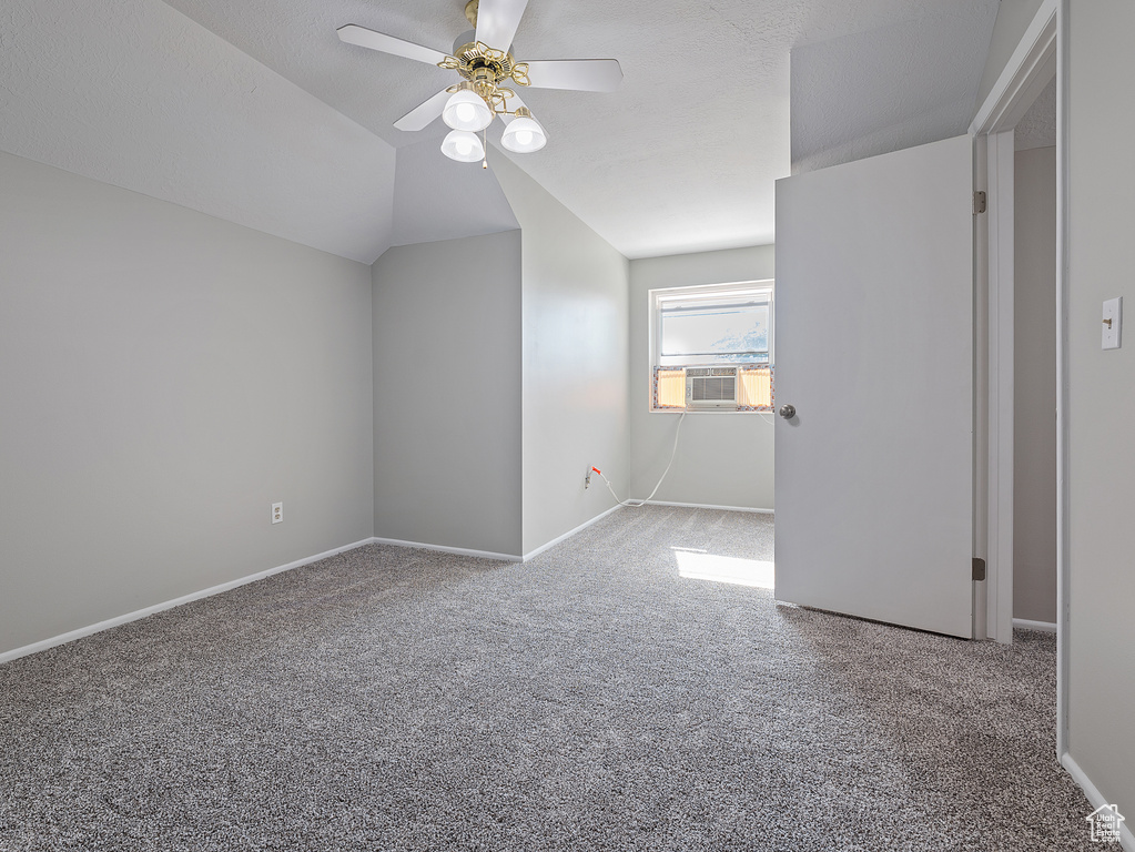 Bonus room featuring carpet floors, ceiling fan, vaulted ceiling, and cooling unit