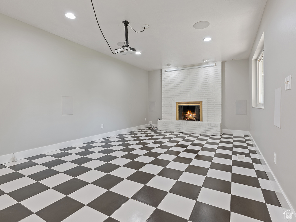 Unfurnished living room featuring recessed lighting and a fireplace