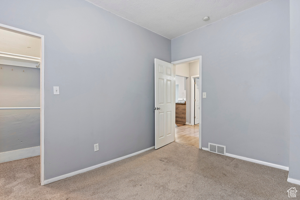 Unfurnished bedroom featuring carpet floors and baseboards