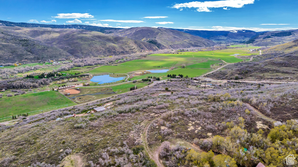 View of mountain background with a local golf course and a large body of water
